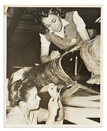 (MILITARY--WORLD WAR TWO.) 3 publicity photographs of women doing war-related factory work.